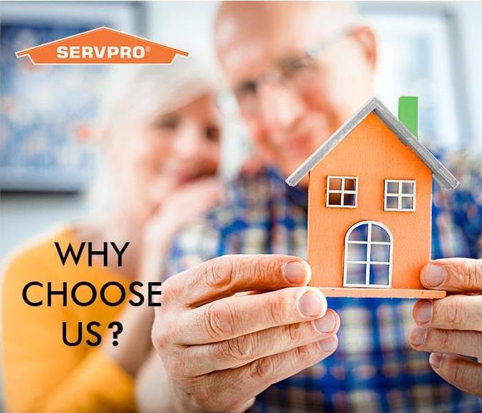 couple looking at model of a home 