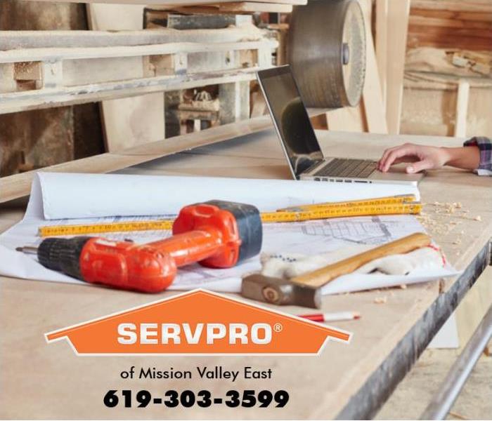 Construction tools sit on a workbench. 