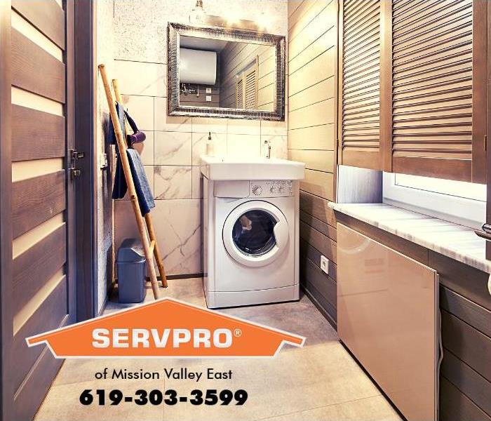 A washing machine is shown in a modern laundry room.