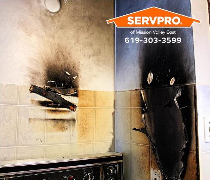 The walls around a stove are damaged by a grease fire.